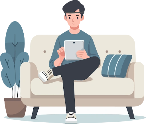 A man sitting on a couch using a tablet