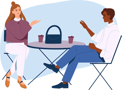 A man and woman having a conversation at a café table
